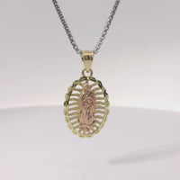 14KT Gold Charm Medium Two Tone Open Stripe Virgin Mary Oval with Diamond Cut Border and Plain Bell