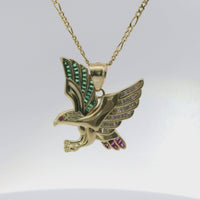 14KT Gold Charm Small Left Facing Soaring Eagle with Baguettes White, Red, and Green CZ Stones Wings, Red CZ Stones Eye and Plain Bell