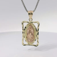 14KT Gold Charm Medium Open Rectangle Frame Two Tone Virgin Mary Oval Coin Center with Diamond Cut Open Frame Border and Plain Bell