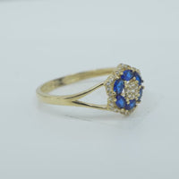 14KT Gold Ring Women's Flower Mini 6 Navy Blue Oval Petals with Round White CZ Stones Center and White CZ Stone Leaf Outline Border and Plain Split Band