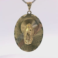 14KT Gold Charm Large Tri Tone Oval Virgin Mary Coin with Graphic Line Background and Plain Bell