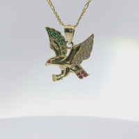 14KT Gold Charm Large Left Facing Soaring Eagle with Round White, Red, and Green CZ Stones Wings, Red CZ Stones Eye and Plain Bell