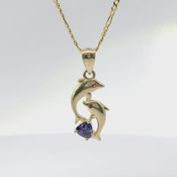 14KT Gold Charm Two Small Dolphins with Plain Bodies, Dark Pink CZ Stones Eyes, Purple CZ Stone Heart Base, and Plain Bell