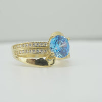 14KT Gold Ring Women's Round Light Blue CZ Center Stone Double White CZ Stone Band with Plain "S" Ribbon