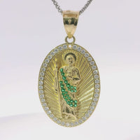 14KT Gold Charm Large Oval St Jude Sunray Coin with Green CZ Stone Robe, White CZ Stone Border and Plain Bell